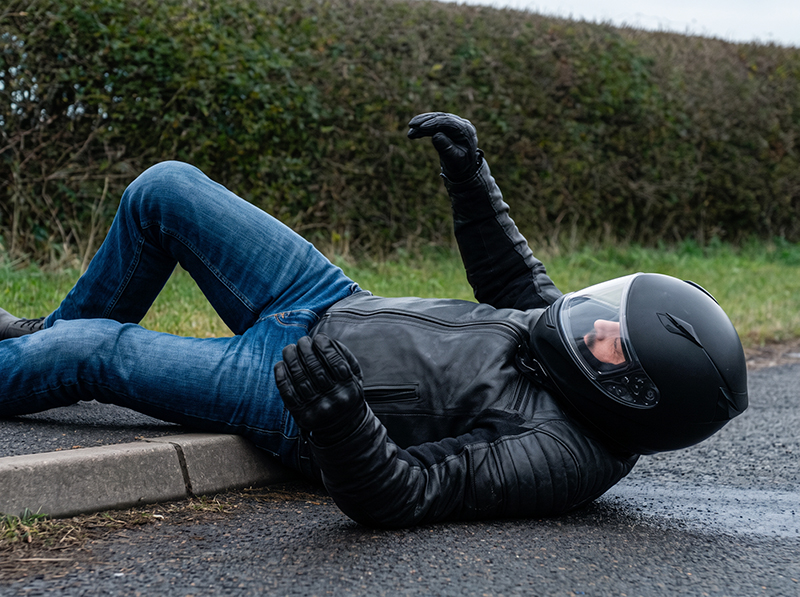 Motorcyclist who has hit kerb